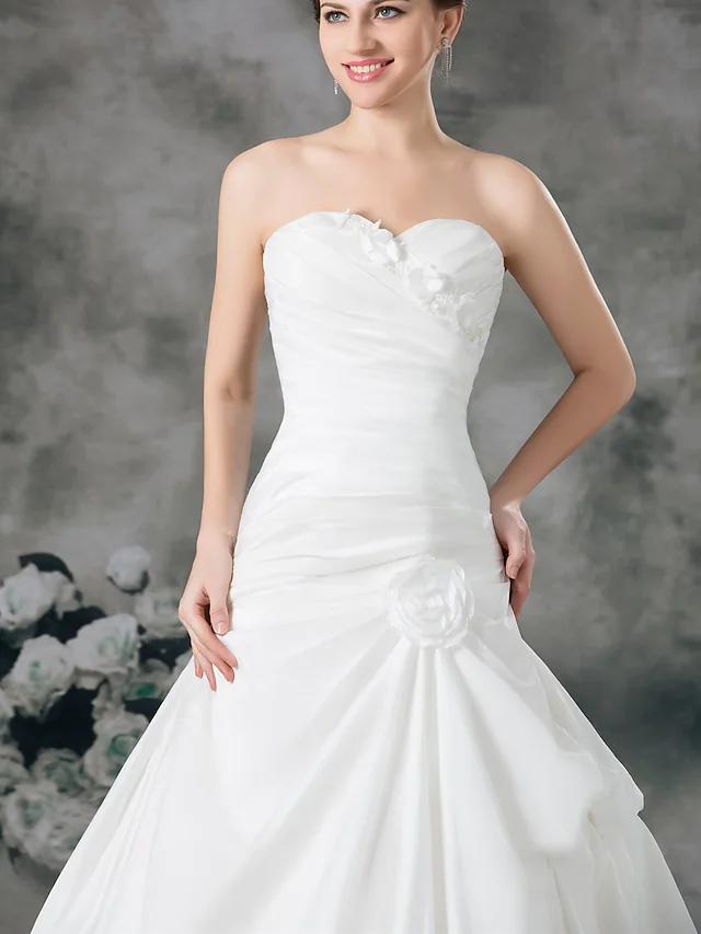 Side view of A-line wedding dress highlighting the court train.