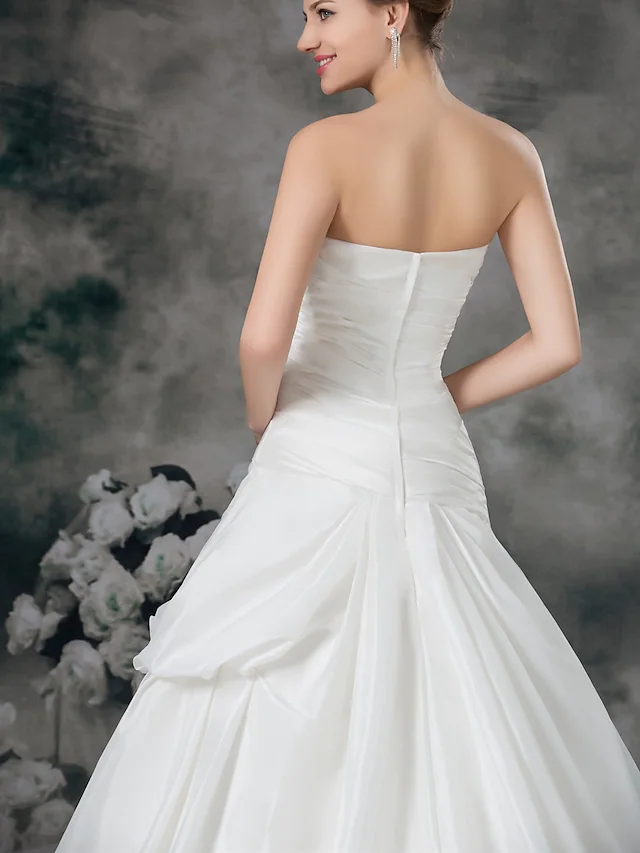 Detailed view of the satin taffeta fabric and ruched side-draped design.