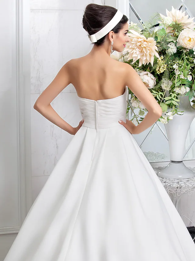 Close-up of the sweetheart neckline and delicate beading on the wedding dress.