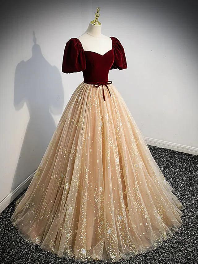 Close-up of the sequin and tulle fabric detail on the A-line dress, highlighting the delicate bows.