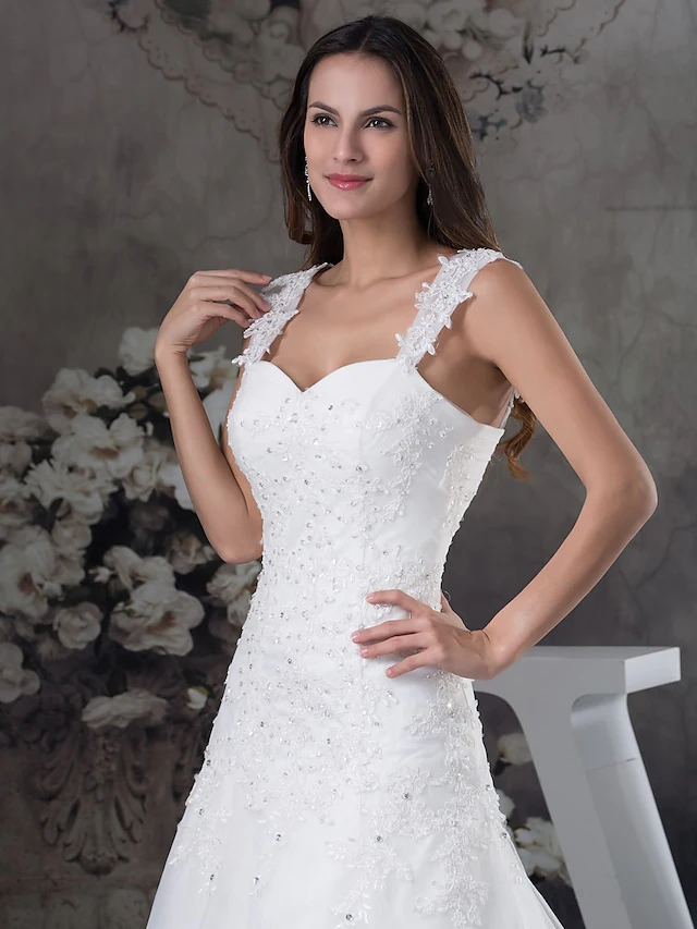 Elegant A-Line wedding dress with sweetheart neckline, spaghetti straps, lace, tulle, and beading appliques.