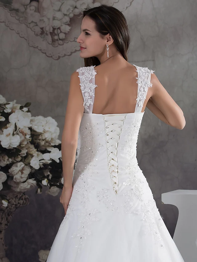 Elegant A-Line wedding dress with sweetheart neckline, spaghetti straps, lace, tulle, and beading appliques.