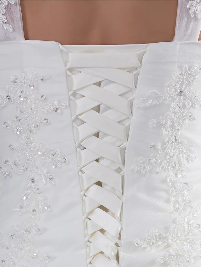 Elegant A-Line wedding dress with sweetheart neckline, spaghetti straps, lace, tulle, and beading appliques.