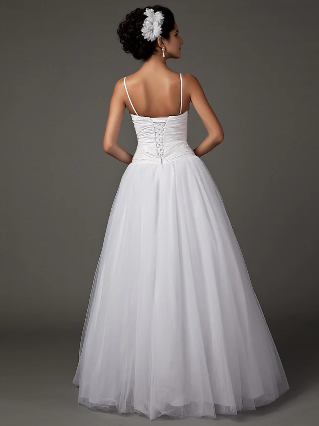 Close-up of the sweetheart neckline and spaghetti straps on the wedding dress.