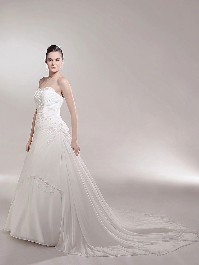 Elegant A-line wedding gown with sweetheart neckline and cathedral train.