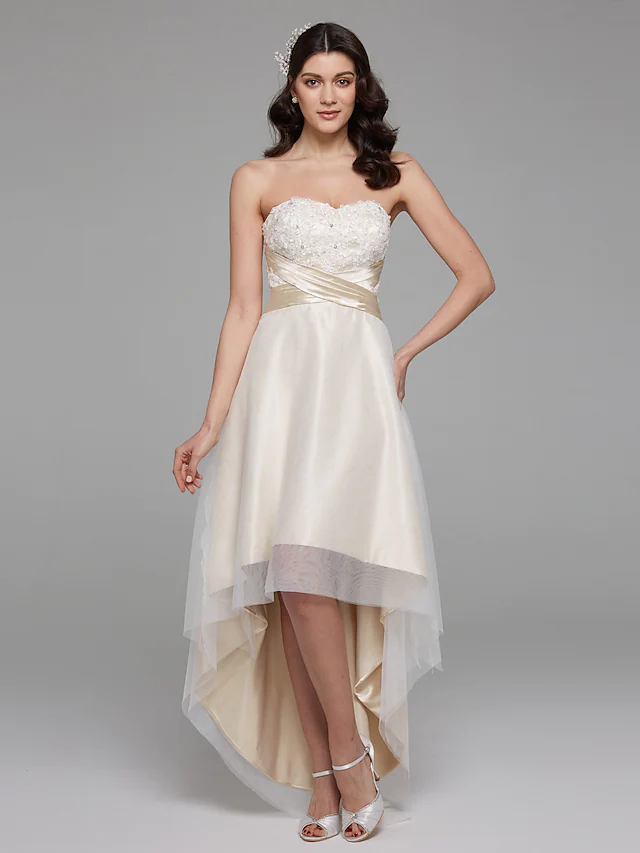 Side profile of strapless A-Line wedding dress with asymmetrical design.