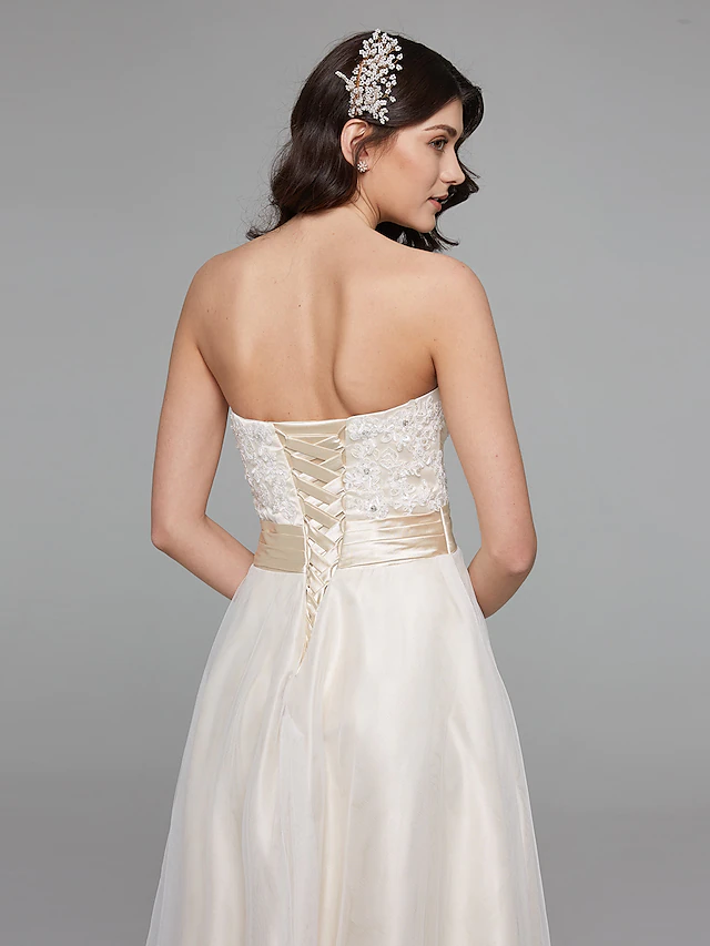 A-Line wedding dress with sweetheart neckline and flowing skirt.