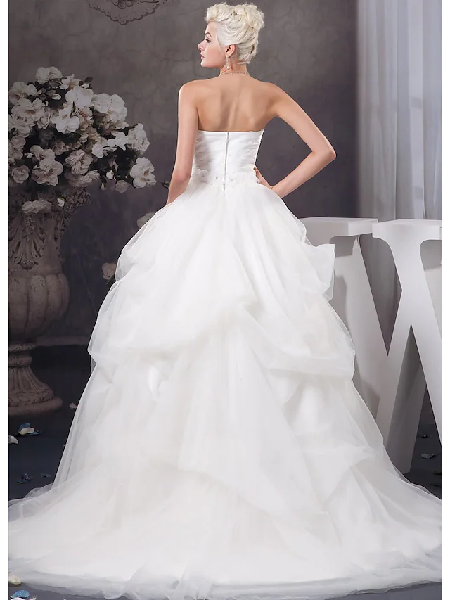 Side profile of strapless A-Line wedding gown with beading.
