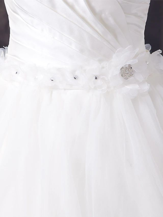 Full view of elegant A-Line bridal gown in organza and satin.