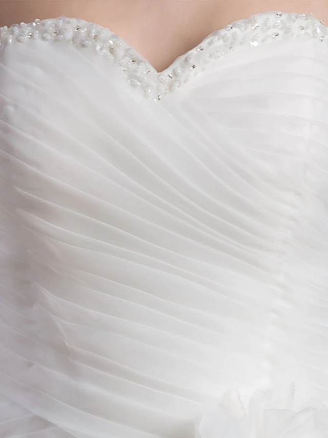 Side profile of the A-line sweetheart wedding dress, highlighting its silhouette and ruffles.