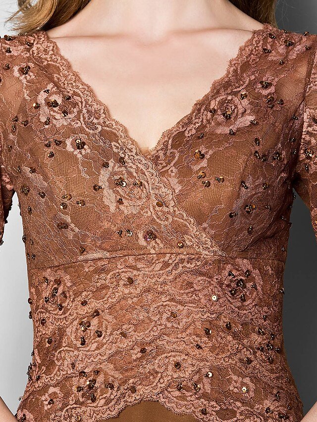 Close-up of the V-neckline and 3/4 lace sleeve with delicate beading.