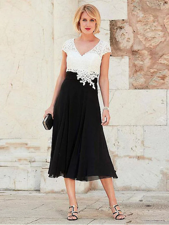 Elegant A-Line V-Neck tea length mother of the bride dress with short sleeves and lace details.
