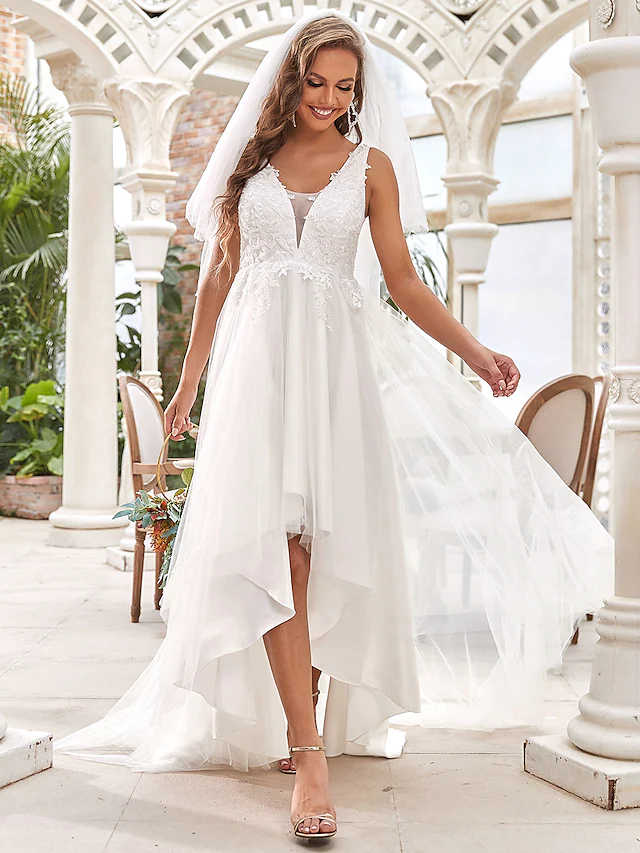 Close-up of the V-neckline and delicate lace details on the wedding dress.