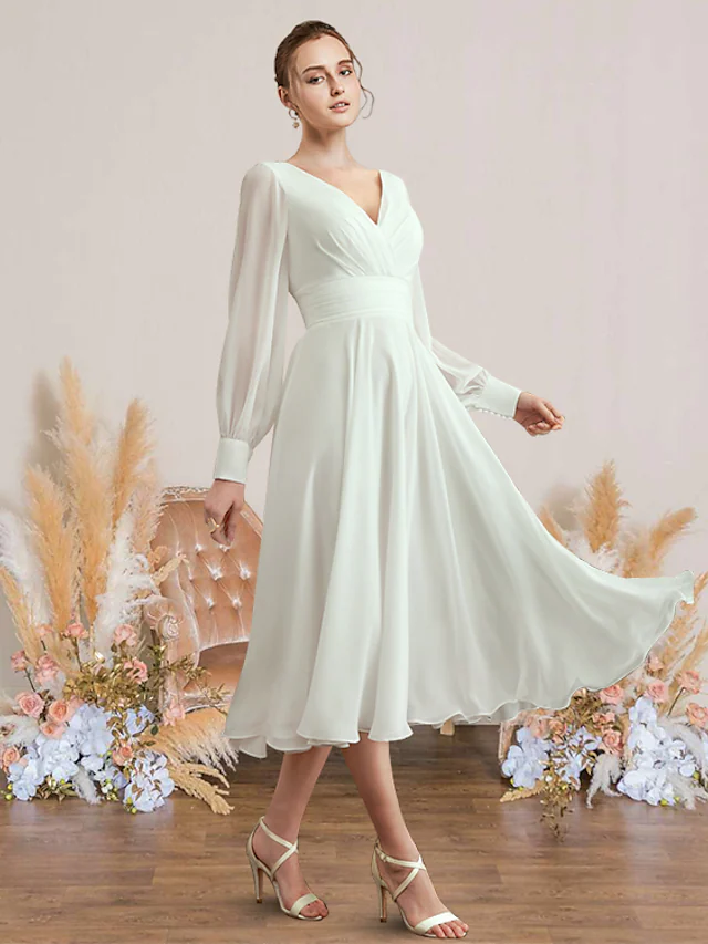 Elegant A-Line V-neck chiffon wedding dress with long sleeves and pleated tea-length skirt.