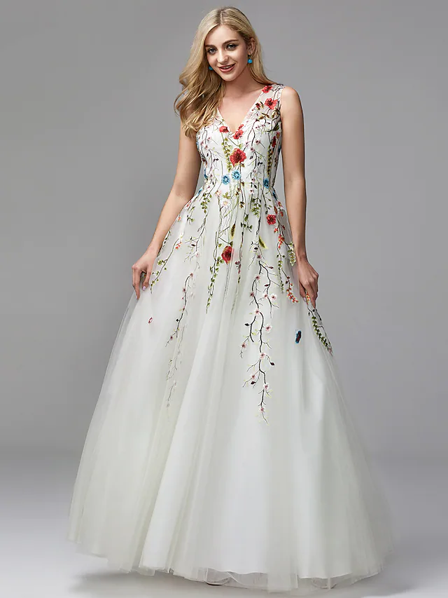 Close-up of the floral lace and embroidery details on the white gown.