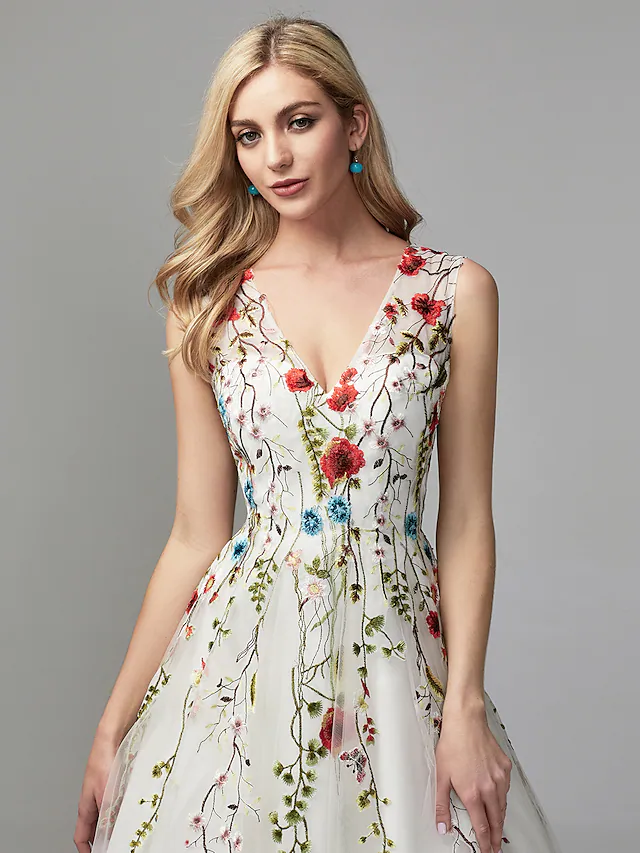 Full length view of the white A-line V-neck floral lace dress.