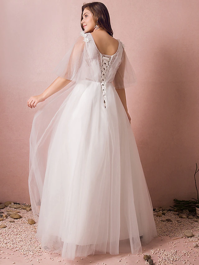 Close-up of lace and beaded appliques on wedding dress.