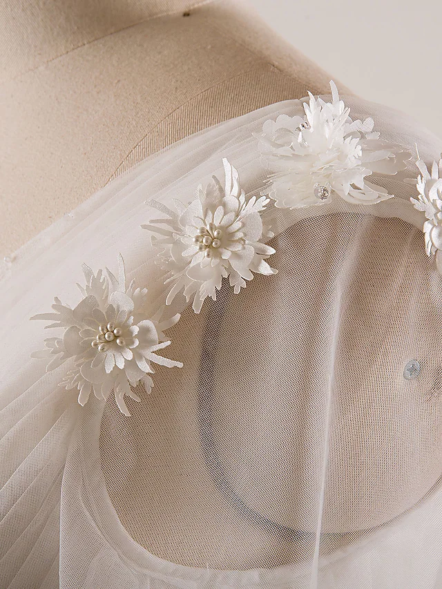 Wedding dress with pearl and bead embellishments.
