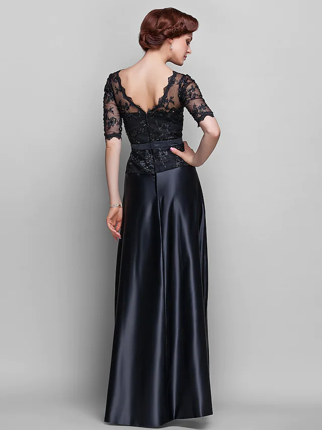 Close-up of the V-neckline and intricate lace beading on the bodice of the dress.