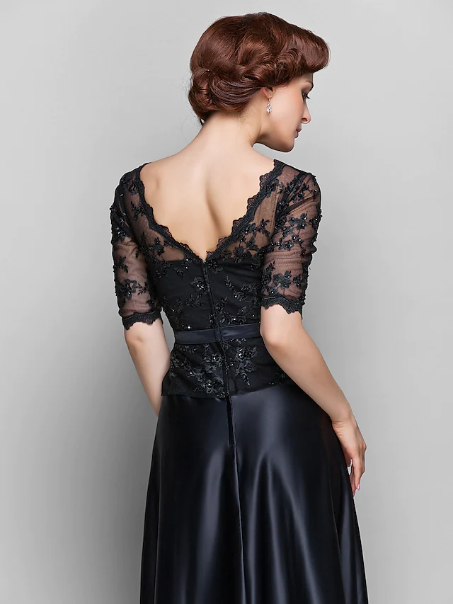 Close-up of the lace and beading details on the dress bodice.