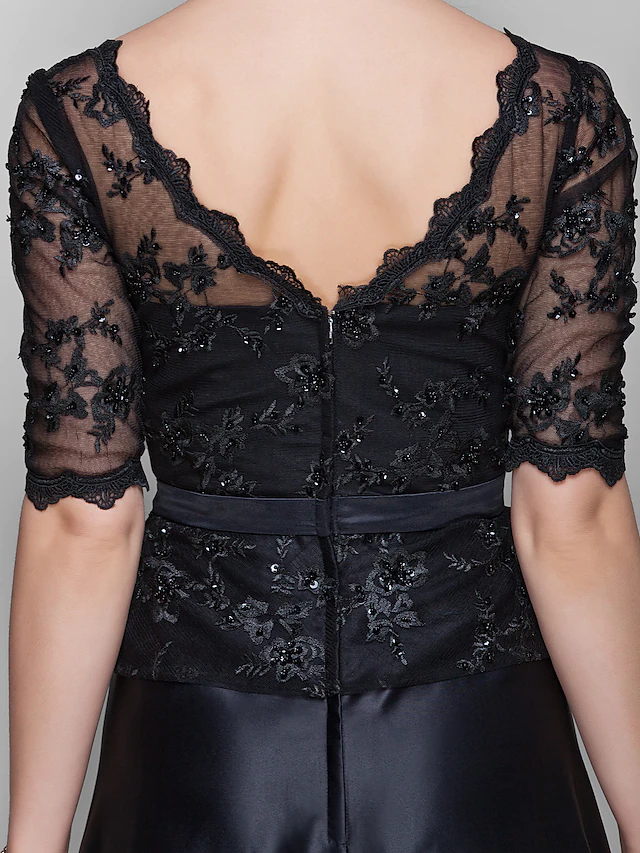 Texture detail of the lace and satin fabric with sparkling beading on the dress.