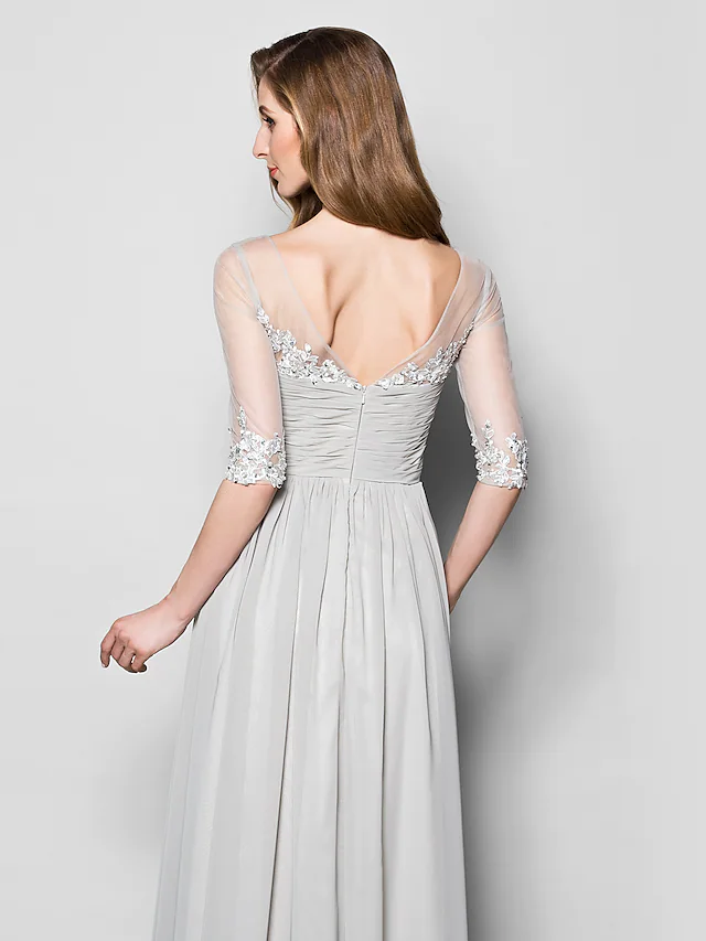 Close-up of the V-neckline and half sleeves of the A-line dress, showing beading and sequin details.