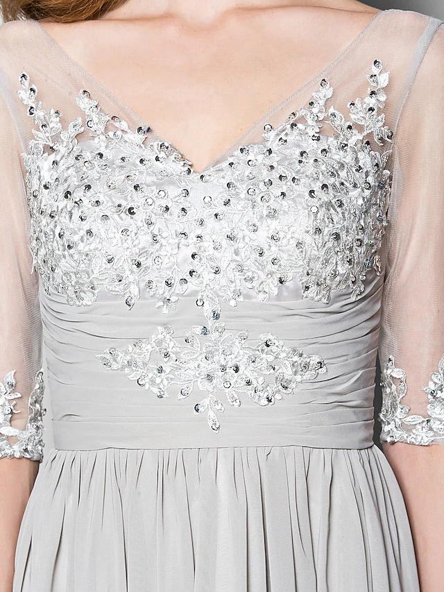 Detail of the ruched bodice with intricate beading and sequin embellishments on the A-line dress.