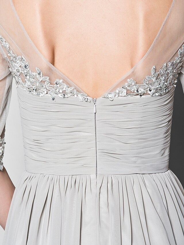 Full length view of the A-line mother of the bride dress, emphasizing its elegant drape and floor-length design.