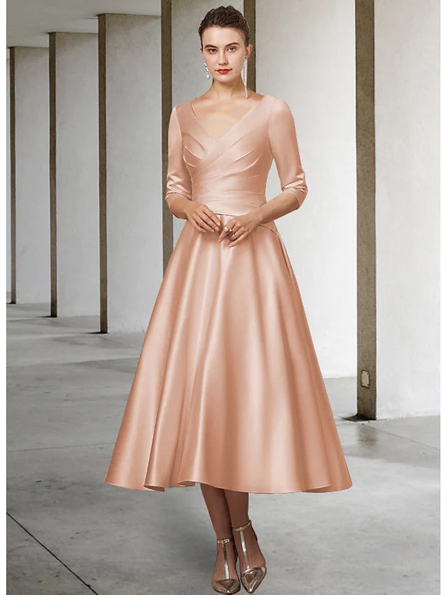 Side profile of the elegant V-neck satin dress, highlighting half sleeves and pleats.