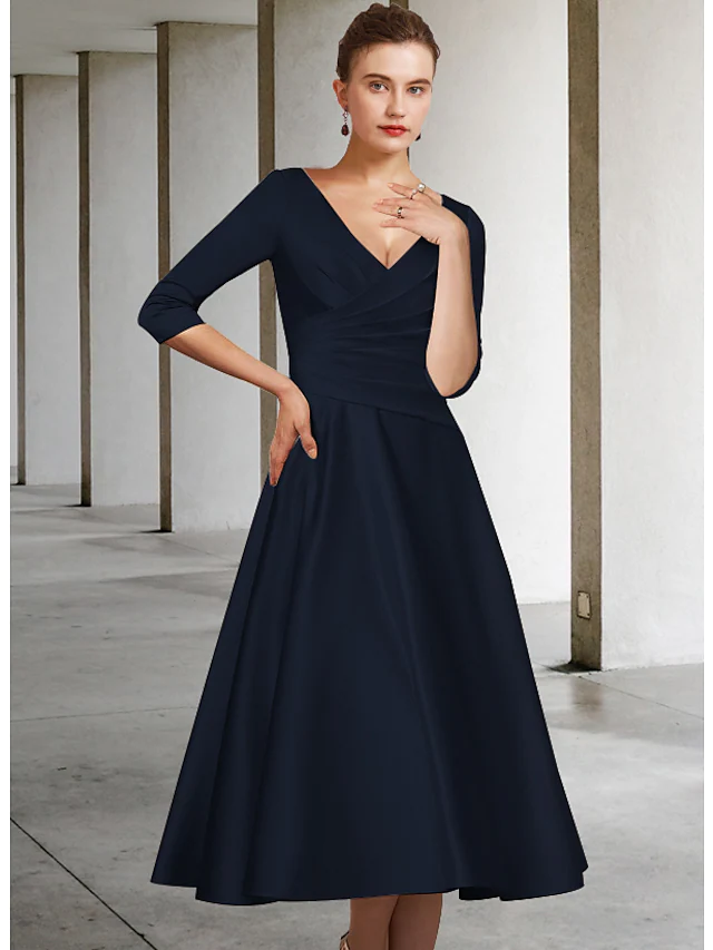Full length view of the Mother of the Bride dress, emphasizing its graceful tea length.