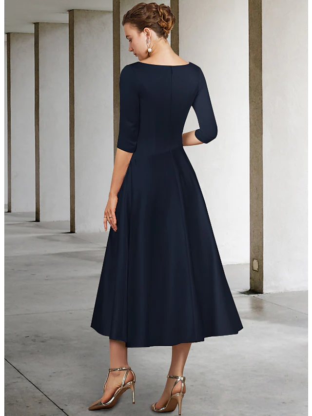 Detailed view of the half sleeves and pleated skirt of the elegant satin dress.