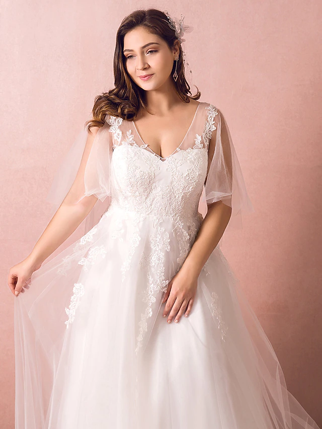 Detail of the delicate appliques on the satin and tulle A-Line wedding dress.