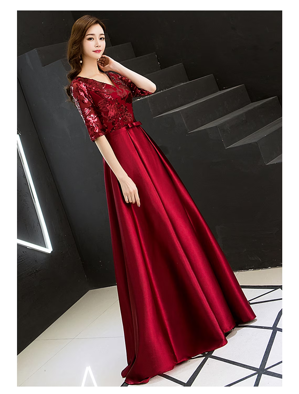 Side view of a woman wearing an A-line sparkle satin formal dress.