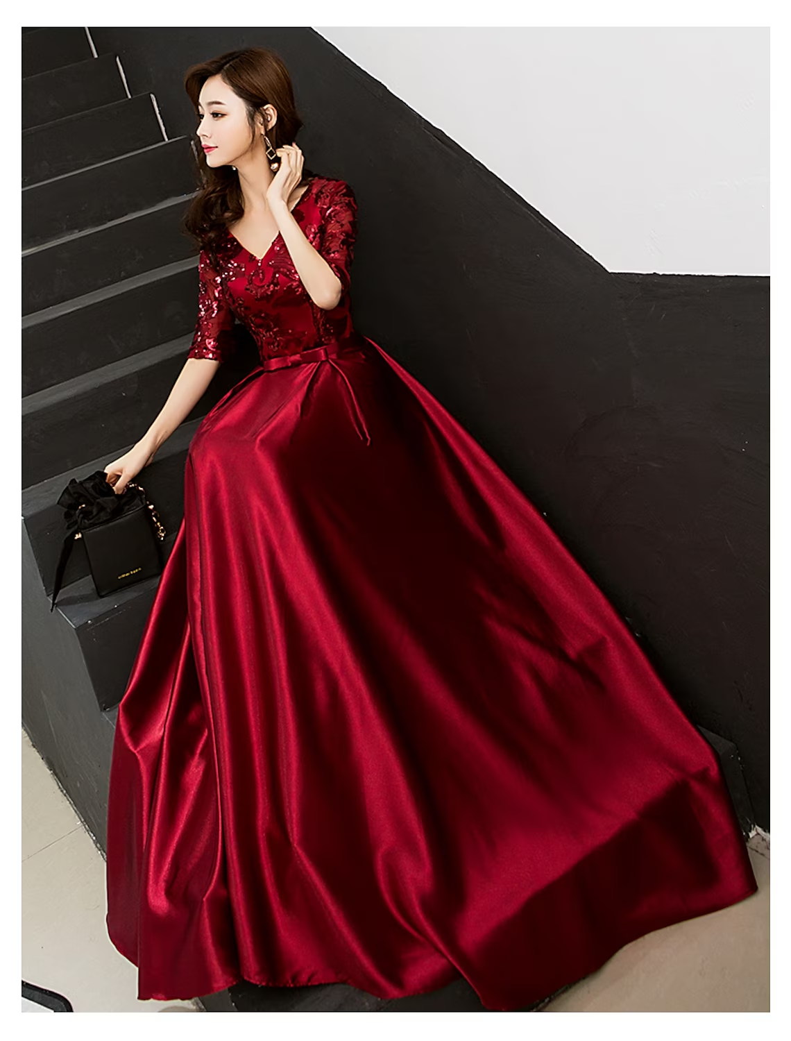 Back view of an A-line sparkle satin formal dress with a flowing skirt.