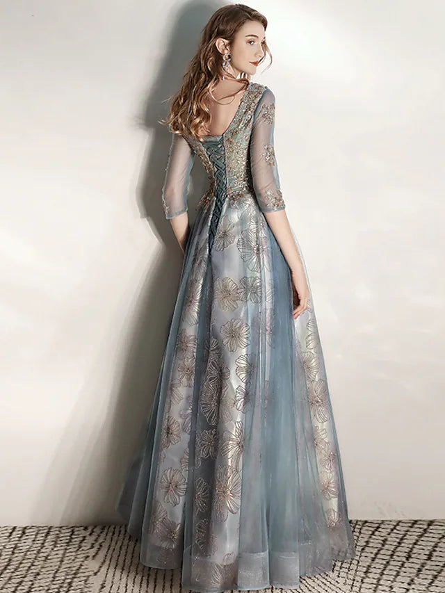 Side view of a flowing A-Line tulle gown with floor length hem.