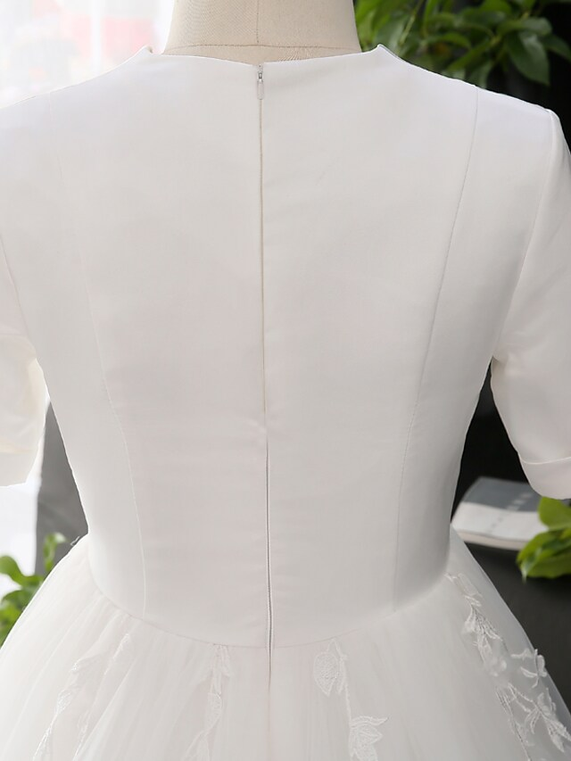 Full length view of the A-line wedding dress with its flowing court train.