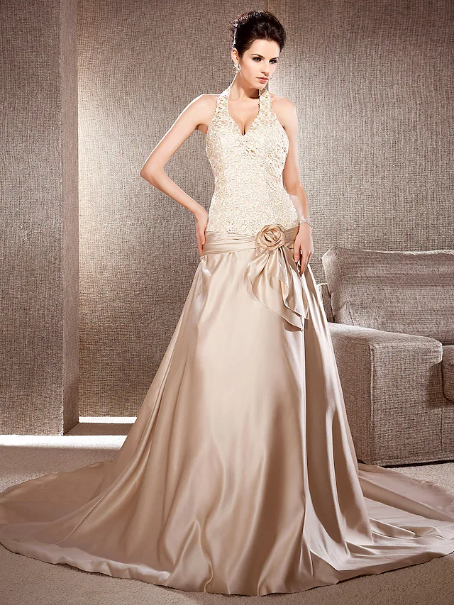 Front view of an elegant A-line V-neck lace and satin wedding dress with a chapel train.