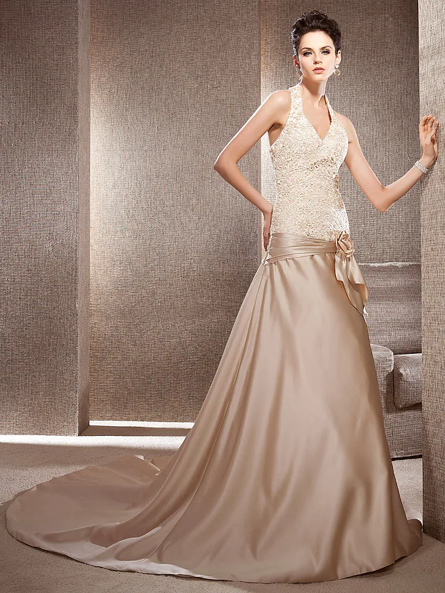 Bridal gown from a slightly elevated angle, showing the full silhouette and intricate lace.
