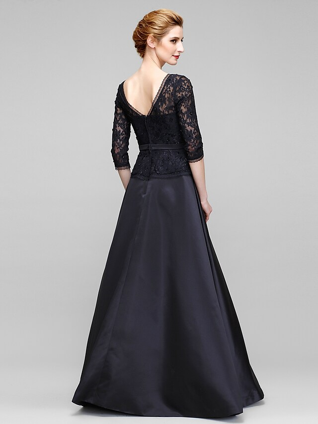 Back view of the A-line mother of the bride dress showing an open back and delicate lace bows.
