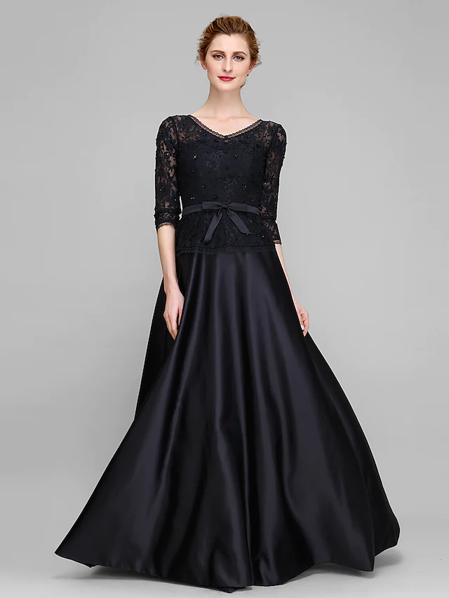 Close-up of the luxurious lace and satin fabric on the half sleeve of the dress.
