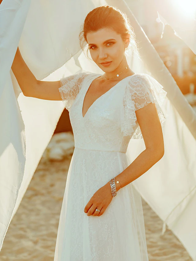 Side view of an A-line V-neck lace wedding dress with short sleeves.