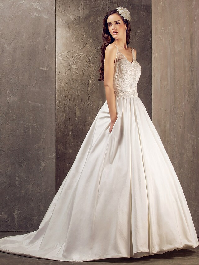 Close-up of lace and taffeta fabric on a bridal dress.