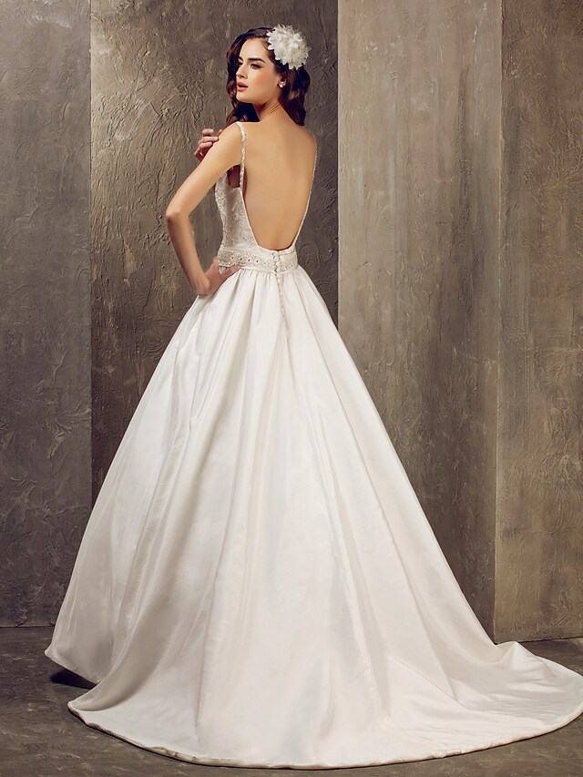 Bride wearing a white V-neck A-line wedding dress.