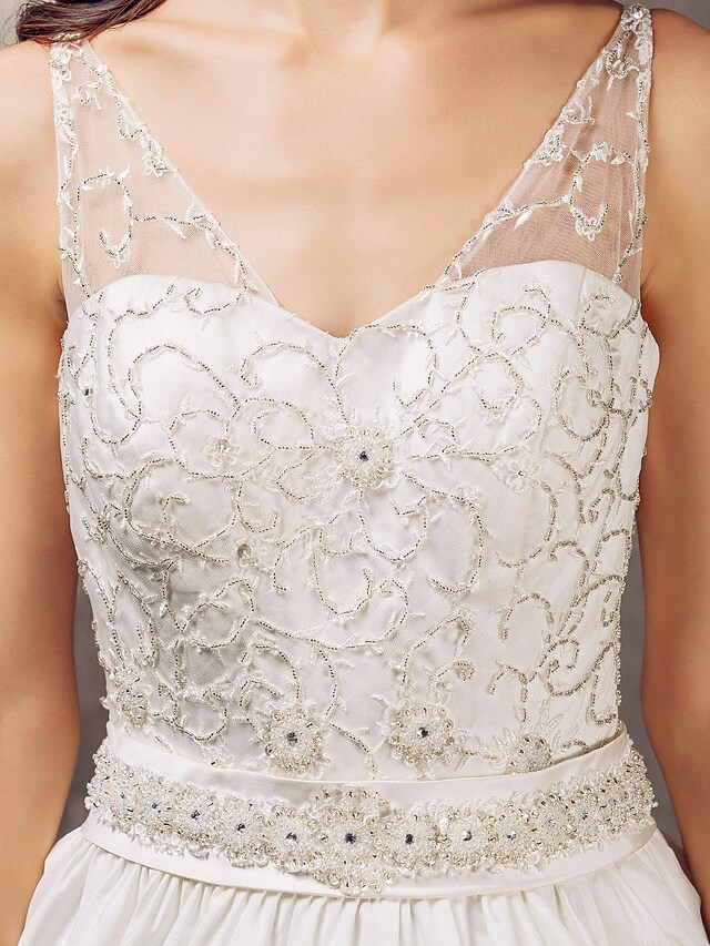 Detail of the V-neckline and bodice of a wedding gown.