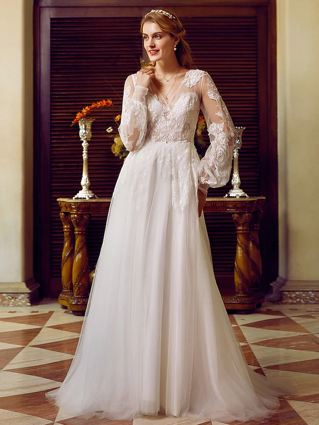 A-Line V-neck wedding dress with lace and tulle, featuring long sleeves and appliques.