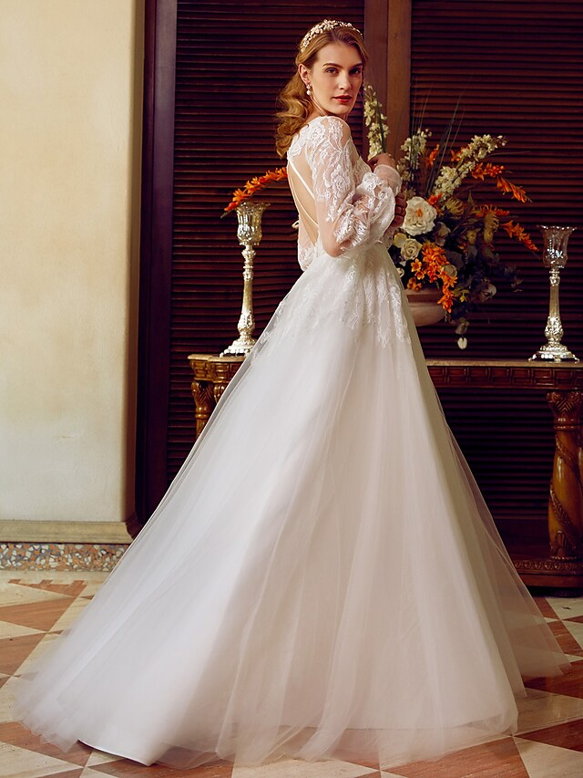 A-Line V-neck wedding dress with lace and tulle, featuring long sleeves and appliques.