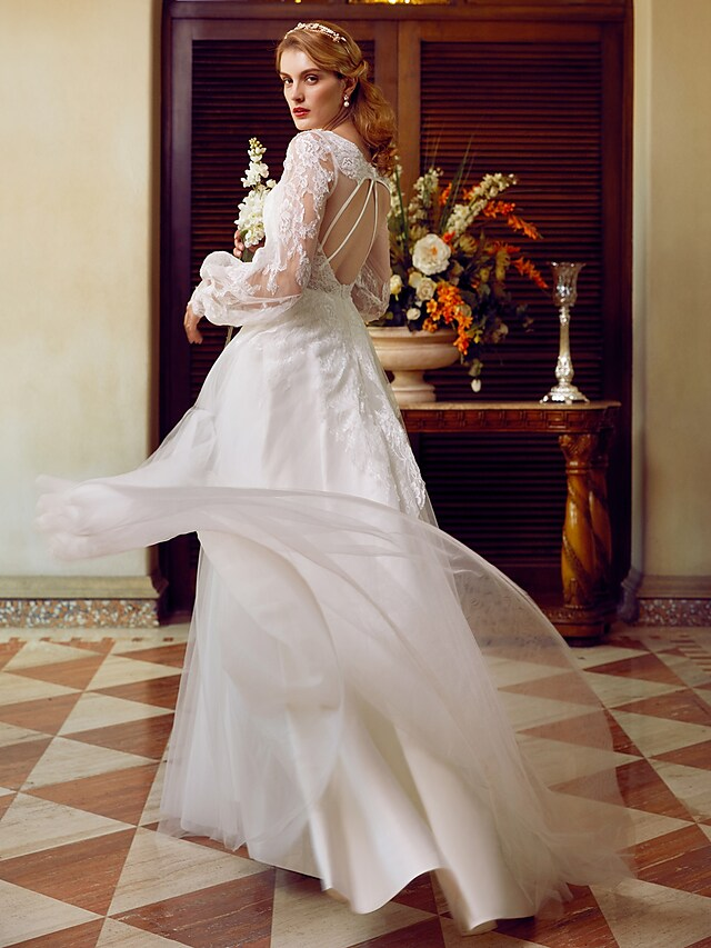 A-Line V-neck wedding dress with lace and tulle, featuring long sleeves and appliques.