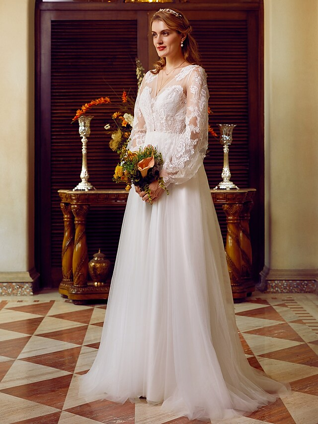 A-Line V-neck wedding dress with lace and tulle, featuring long sleeves and appliques.