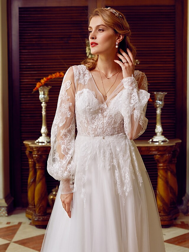 A-Line V-neck wedding dress with lace and tulle, featuring long sleeves and appliques.