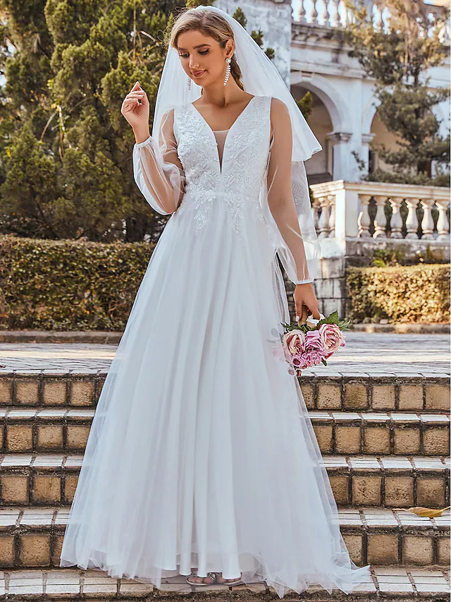 Side view of a white A-line wedding dress showing pleated skirt and V-neck.